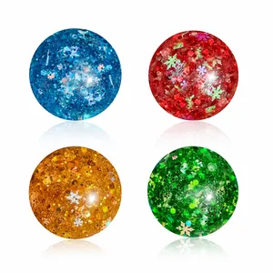 Set di quattro palline antistress colorate con fiocchi di neve e glitter natalizi.