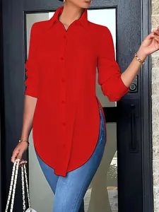 Detail of women's red long-sleeved shirt featuring an asymmetrical hem and button front.