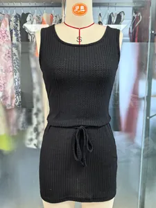 Close-up of black sleeveless knitted tank dress with ribbed texture and drawstring waist.
