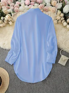 Back view of elegant light blue long sleeve shirt with irregular curved hem design