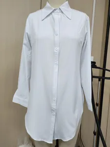 Classic white long-sleeve button-down blouse with irregular hem shown on a mannequin