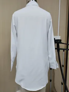 Back view of women's white long-sleeve shirt with stylish irregular hem detail
