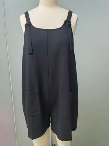 Detailed front view of a black sleeveless jumpsuit featuring shoulder ties and pockets