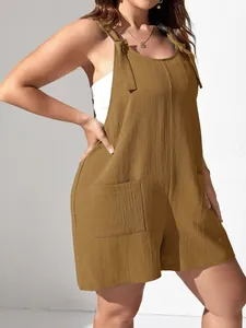 A close-up view of a brown sleeveless romper with front pockets and adjustable tie straps.