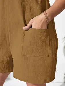 Close-up detail of textured crepe fabric and side pocket on a solid brown women's romper