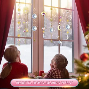 Close-up of golden suncatchers with crystal prisms catching light in a window