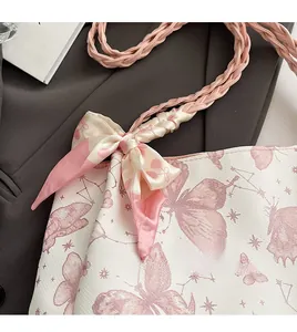 Detail of butterfly print tote bag with silk scarf and braided shoulder strap
