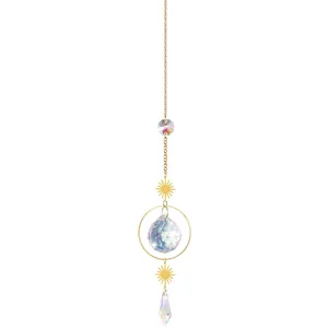 Detailed view of a crystal suncatcher hanging with gold sun-shaped charms on a chain