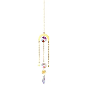 Detailed view of crystal suncatcher with moon and star gold-tone metal accents.
