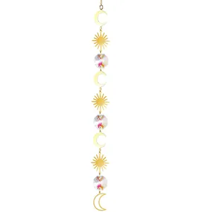 Close-up detail view of vertical crystal suncatcher with golden moon and sun metal accents.