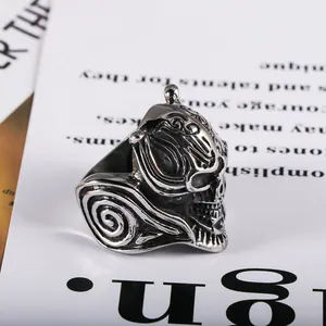 Close-up detail of vintage titanium steel ring with intricate skull and wolf tooth carving.