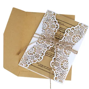 Elegant white laser-cut hollow lace wedding invitation set with kraft paper card and envelope