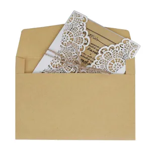 Elegant laser-cut wedding invitation set with kraft paper envelope and jute twine
