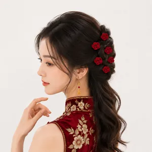 Close-up of elegant red rose hairpins and gold earrings on a traditional Chinese bun