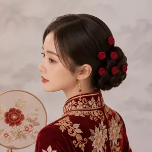 Elegant red rose U-shaped hairpins on model for traditional Chinese bridal hair styling.