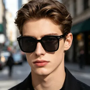 Fashionable close-up of men's square polarized sunglasses with black frames on a model.