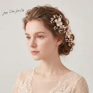Detail showing a handmade luxury gold flower and pearl hair clip on an elegant hairstyle