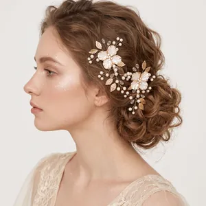 Detailed view of handmade pearl and gold flower hair clips on an elegant bridal hairstyle.