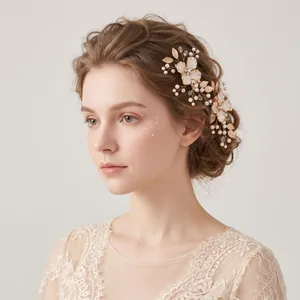 Elegant bridal hair clip featuring gold flowers and pearls worn in a vintage style