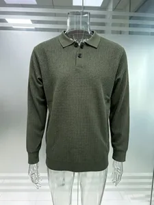 Detailed view of men's olive green waffle knit long-sleeve polo sweater with buttons