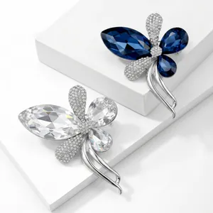 Detailed view of elegant butterfly brooches with shimmering blue and clear crystals