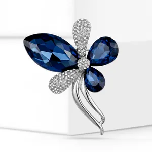 Macro detail of elegant blue crystal brooch with sparkling rhinestones in silver finish
