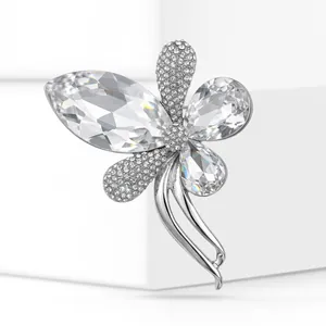 Detailed close-up of a high-end flower brooch with sparkling clear rhinestones