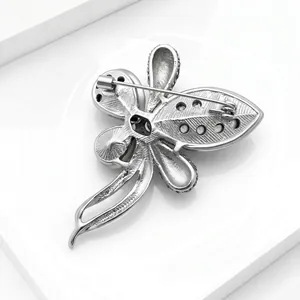 Detailed back view of a silver rhinestone brooch with secure safety pin closure