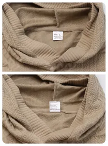 Macro view of textured tan jacquard hoodie showing interior size and fabric care labels