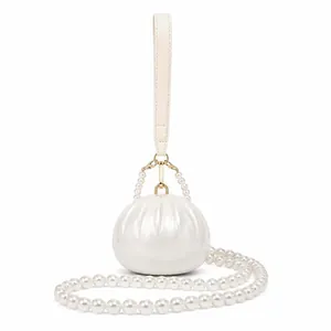 Elegant pearlescent shell-shaped acrylic evening clutch bag with luxury pearl strap