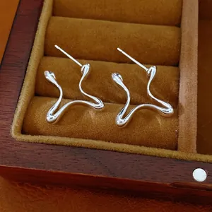Minimalist silver stud earrings featuring unique geometric wavy line design