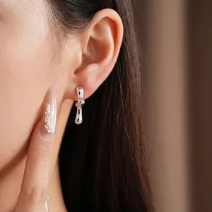 Minimalist geometric silver stud earrings shown on model for an elegant and modern fashion look