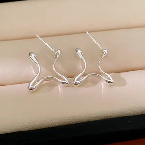 Detailed view of minimalist silver geometric stud earrings with sleek curved lines