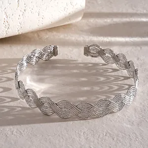 Macro view of silver wavy braided choker showing intricate cross-texture details