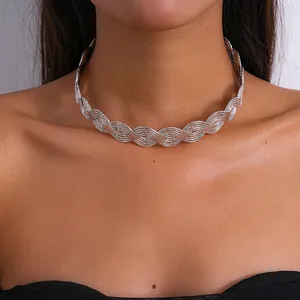 Close-up of a stylish silver wavy braided metal choker necklace worn by a female model