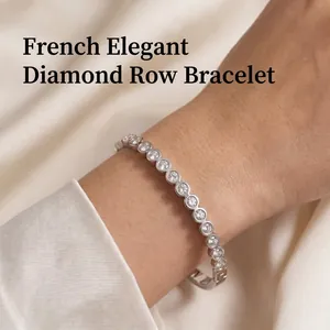 Detailed view of an elegant stainless steel bracelet with round sparkling crystals on a wrist.