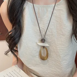 Close-up view of vintage resin geometric pendant sweater chain necklace for women