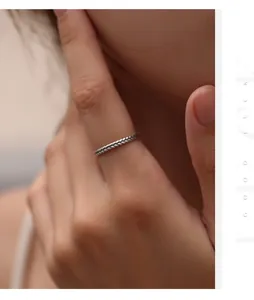Detail of a vintage S925 sterling silver ring with a braided wheat ear design on finger