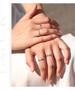 Close-up of S925 sterling silver rings with wheat leaf designs on model hands