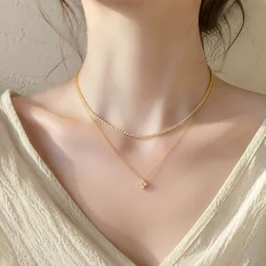 Elegant layered 18k gold plated stainless steel necklace with sparkling clover pendant.