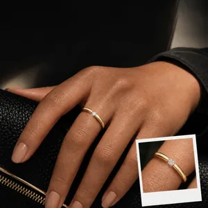 Minimalist gold stainless steel open ring for women featuring a single round diamond accent