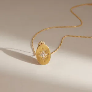 Detailed close-up of a gold-plated stainless steel necklace with starburst pendant