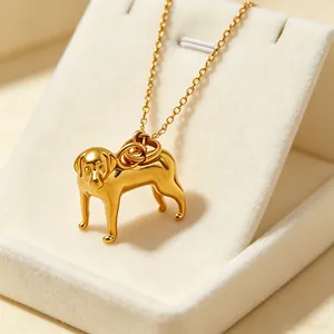 Detailed macro view of a 18k gold plated dog pendant on a stainless steel necklace.