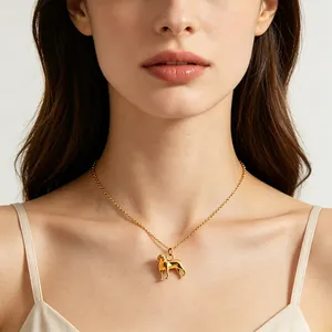 Close-up of a model wearing a 18k gold-plated stainless steel dog pendant necklace.