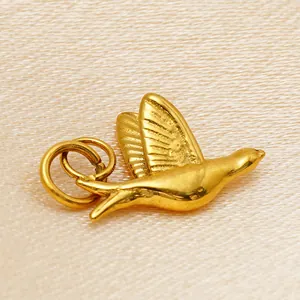 Detailed view of a gold-plated stainless steel bird charm for DIY jewelry