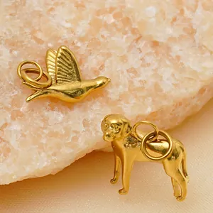Detail of 18k gold plated stainless steel bird and dog charms for jewelry making