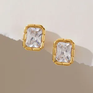 Detailed view of gold titanium steel earrings with rectangular zircon and ribbed edges