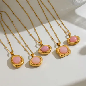 Close-up detail of various pink quartz stone pendants on gold stainless steel ball chains