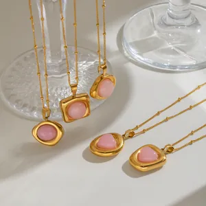 Detailed view of assorted pink crystal pendants on gold-plated stainless steel chains.