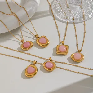Detail showing gold stainless steel necklaces with various pink gemstone pendants